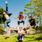 The band members of Pretoria posing in the air.