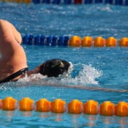 A USC swimmer swims freestyle