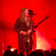 Image of singer girl in red playing guitar and singing