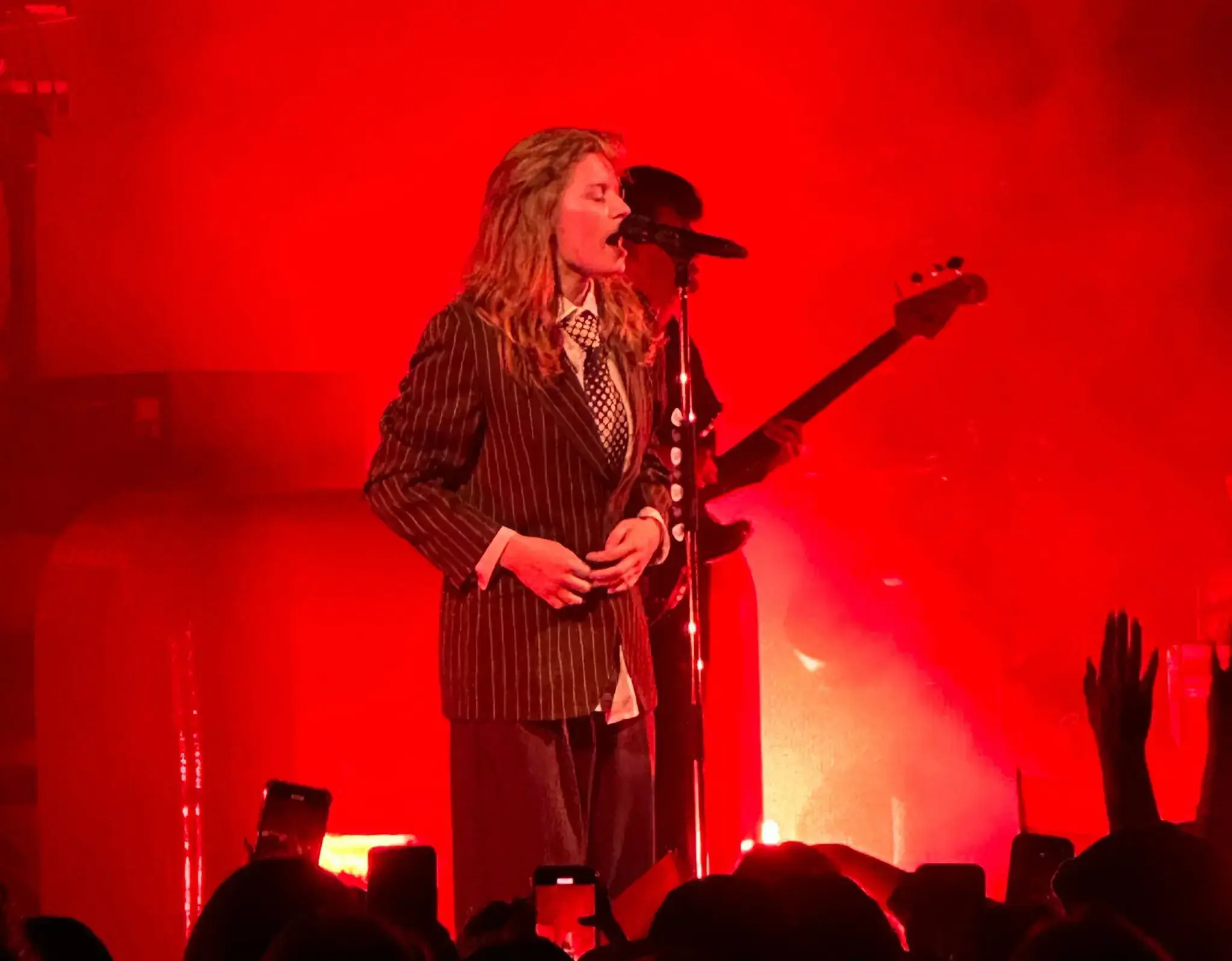 Image of singer girl in red playing guitar and singing