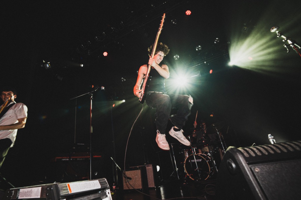 Jack Kallweit jumps while doing a guitar solo.