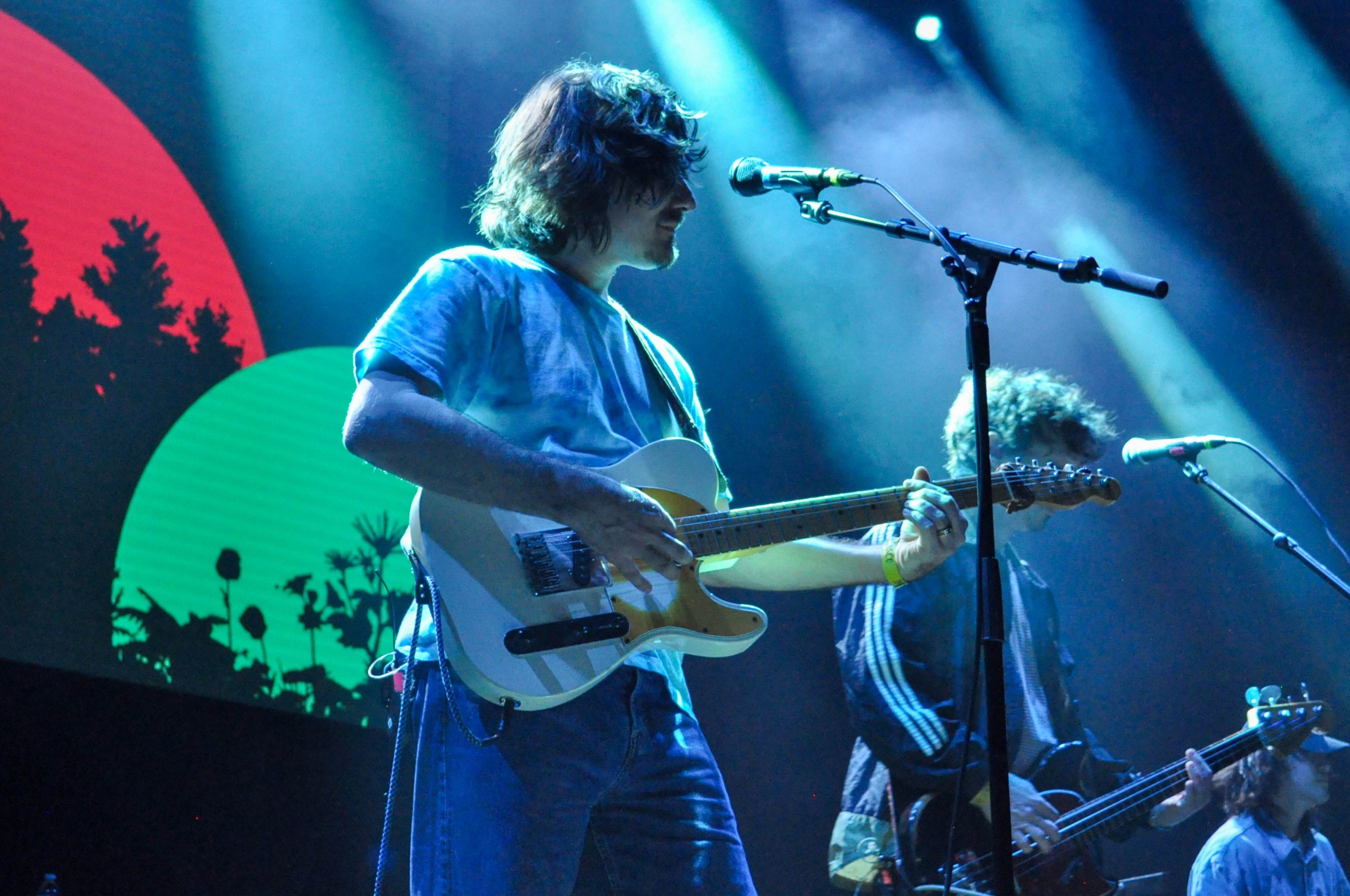 A man plays a guitar on stage.