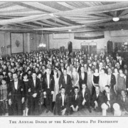 Black and white image of Kappa Alpha Psi fraternity in a ballroom.