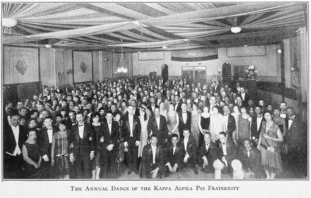 Black and white image of Kappa Alpha Psi fraternity in a ballroom.