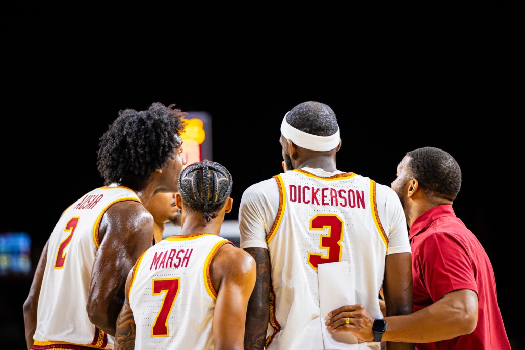 Men's basketball team huddles together