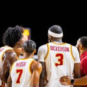Men's basketball team huddles together