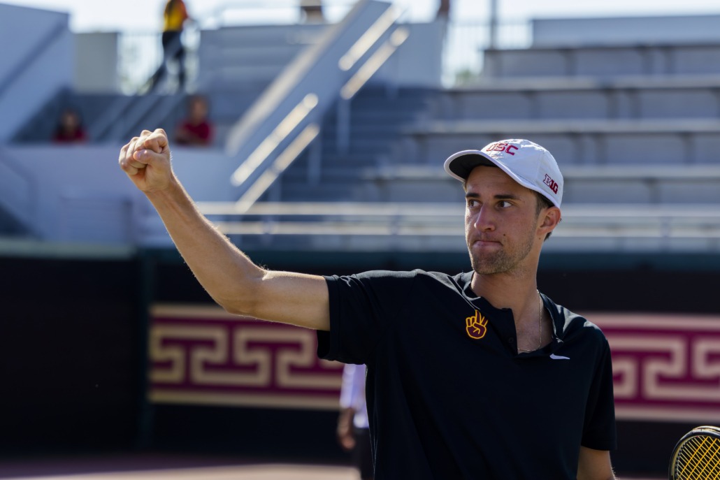 Branko Djuric pumps his fist as he secures the doubles win against Northwestern