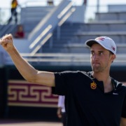 Branko Djuric pumps his fist as he secures the doubles win against Northwestern
