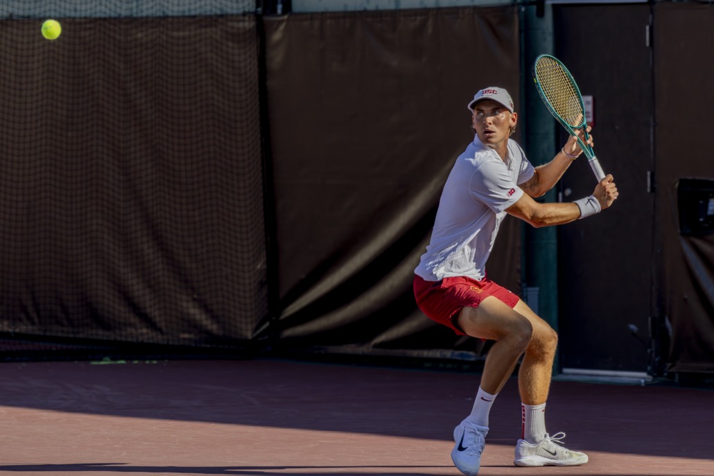 Nathan Trouve hits a tennis ball.