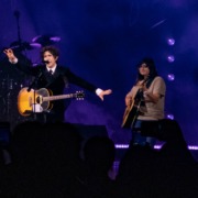 Ricky Montgomery performing besides fan Hailey Salinas playing guitar.