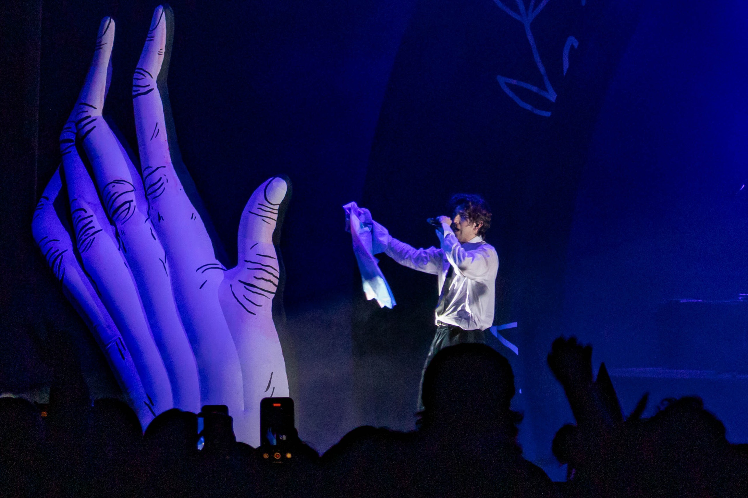 Ricky Montgomery performing next to an inflatable hand.