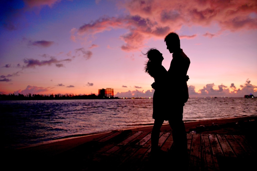 A couple on the beach in during sunset