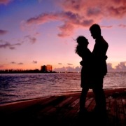 A couple on the beach in during sunset