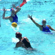 A USC water polo player shoots past the UCLA goalie