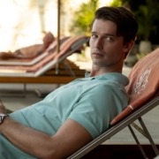 Patrick Schwarzenegger lounges on a beach chair.