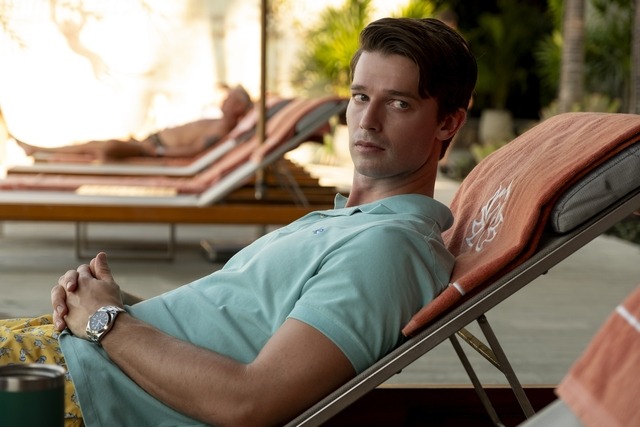 Patrick Schwarzenegger lounges on a beach chair.