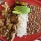 The carne asada platter from La Maria features fried plantains, avocado, beans and rice.