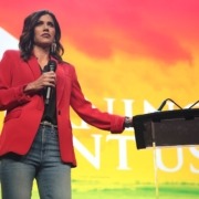 Kristi Noem speaking at a Turning Point USA event,