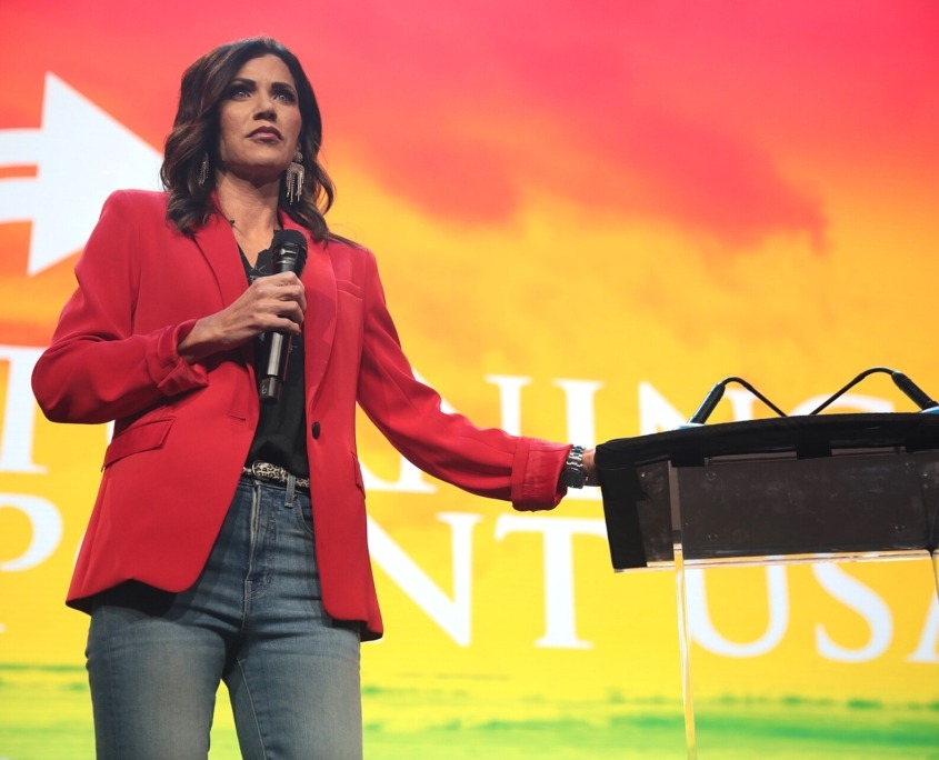 Kristi Noem speaking at a Turning Point USA event,