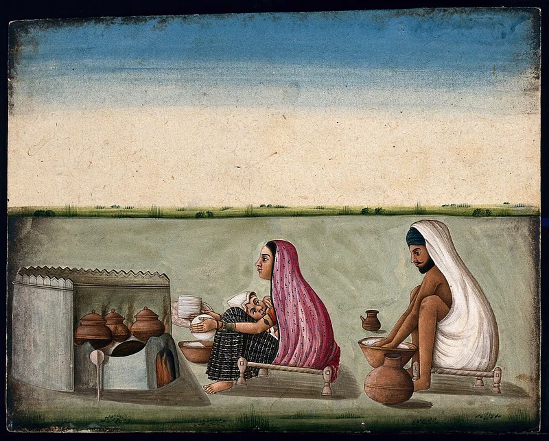 art of women making roti with mans help.