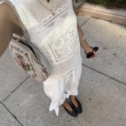 White crochet top and white linen pants.