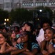 Front row audience members smiling during the concert.