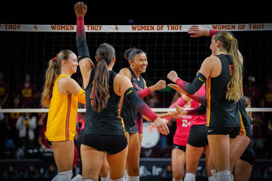 Junior middle blocker Mia Tvrdy celebrates with trojan teammates.