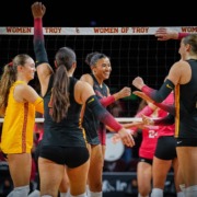 Junior middle blocker Mia Tvrdy celebrates with trojan teammates.