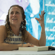 Jodi Picoult talking with a book open at the LBJ Presidential Library.
