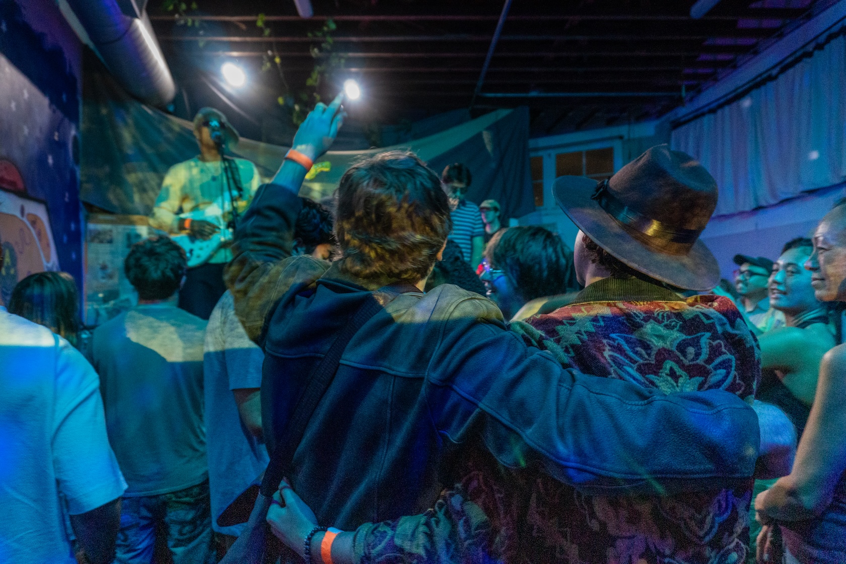 Michael Tringale dressed in an Indiana Jones costume and friends watch the concert from the audience.