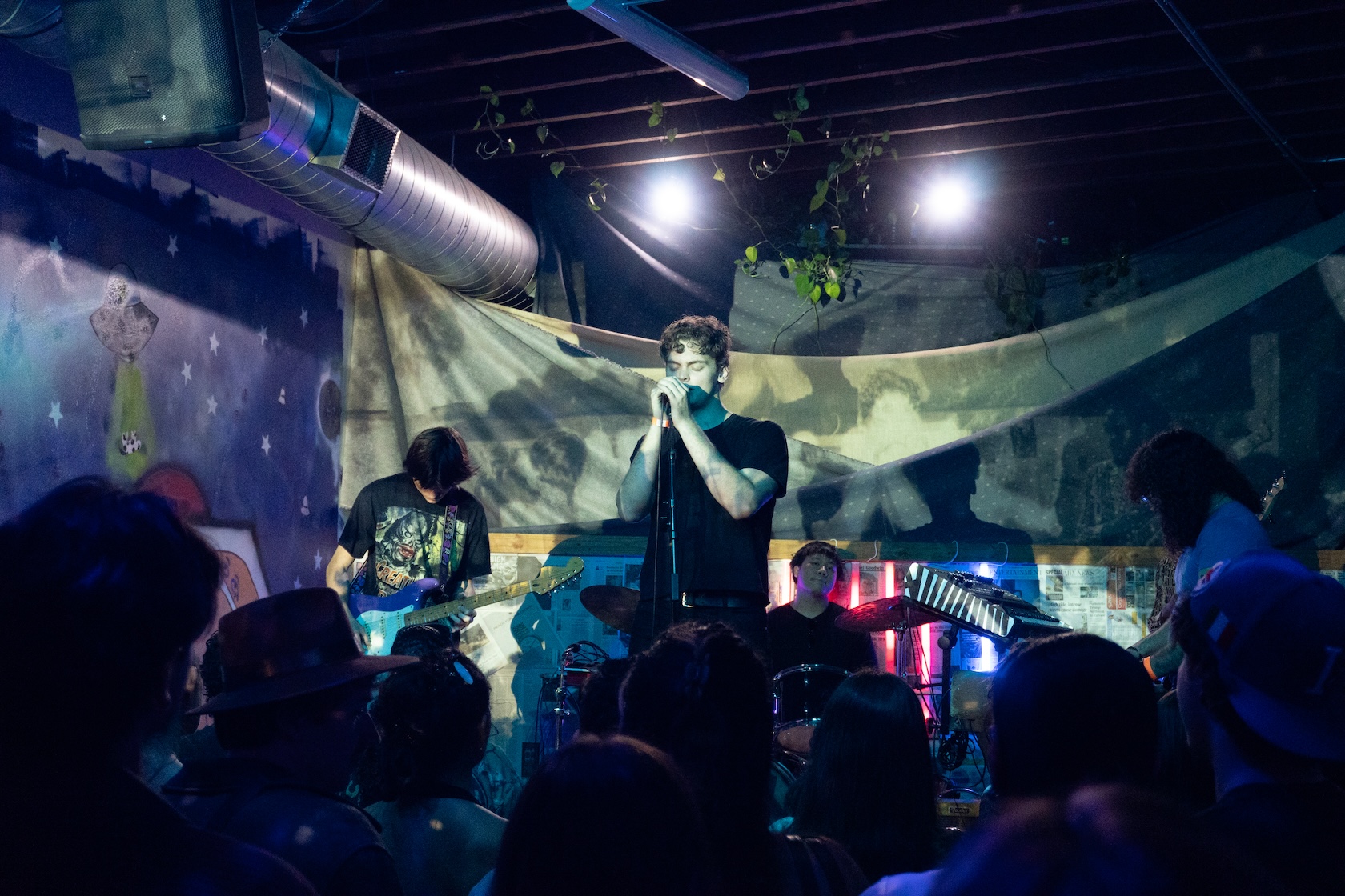 Junah Blue sings into a microphone.