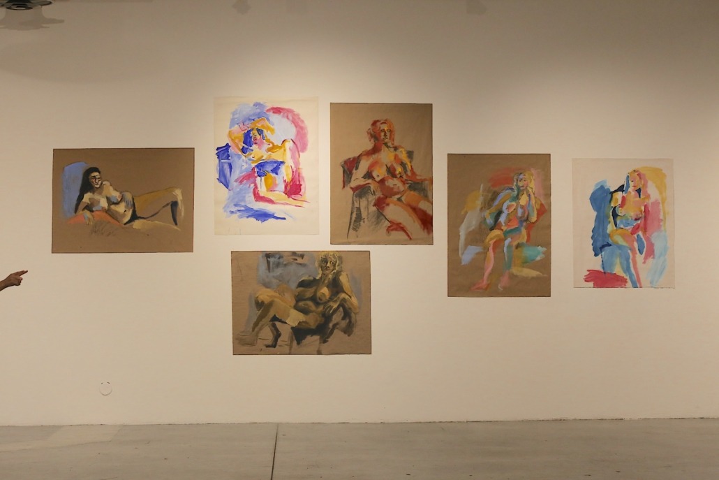 A wall with finger-painted figures at the gallery.