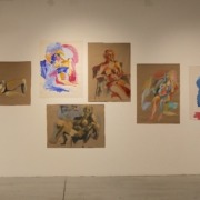 A wall with finger-painted figures at the gallery.