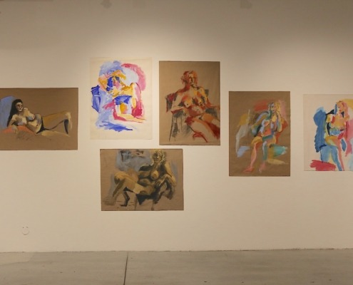 A wall with finger-painted figures at the gallery.